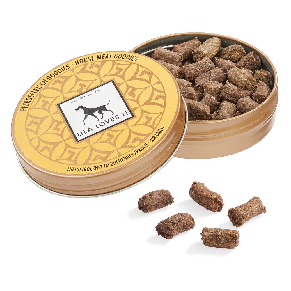 Geöffnete Dose mit 'Pferdefleisch-Goodies'. Logo mit Hund. Text: 'LILA LOVES IT'. Braune, zylindrische Snacks liegen daneben.