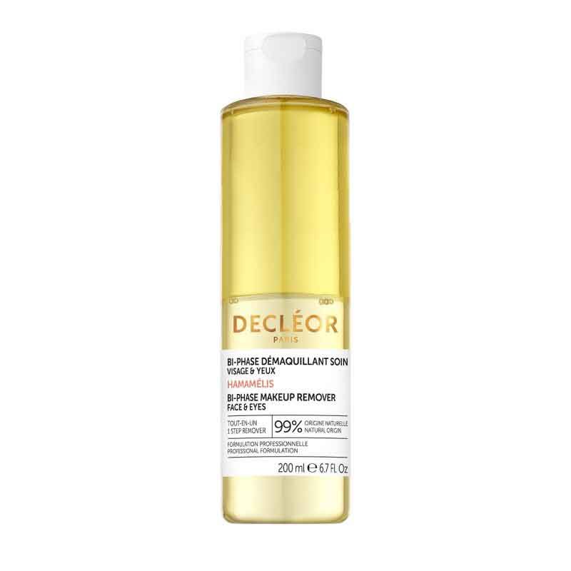 Eine Flasche Decleor Bi-Phase Make-up Entferner. Gelbe Flüssigkeit in einer zylindrischen Flasche mit weißem Deckel. Text: Bi-Phase Demaquillant Soin Visage & Yeux.