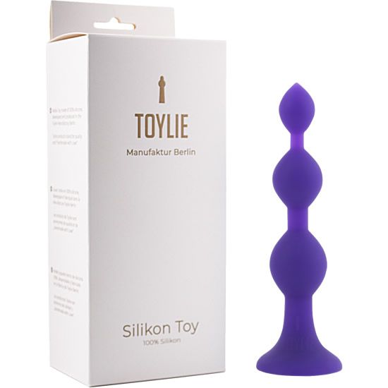 Lila Anal-Dildo aus Silikon. Drei kugelförmige Elemente, Basis mit breitem Rand. Verpackung mit Markenlogo und Schriftzug.