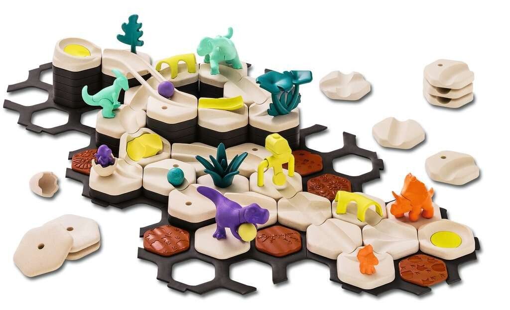 Buntes Dinosaurierspielzeug-Set mit verschiedenen Figuren und Bausteinen auf einer sechseckigen Basis.