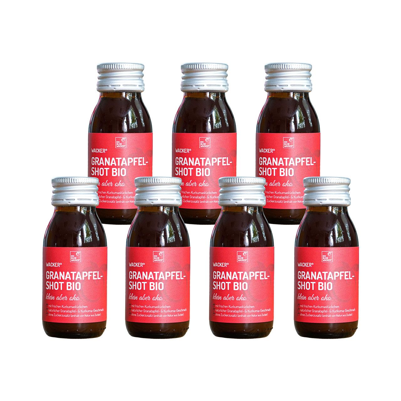 Sieben Flaschen mit roter Etikettierung. Aufschrift: Granatapfel Shot Bio. Silberne Verschlüsse.
