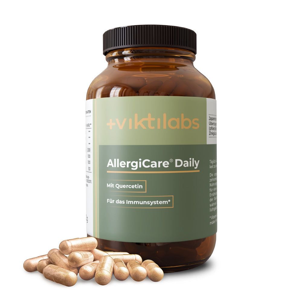 Braune Glasflasche mit AllergiCare® Daily Kapseln. Aufschrift: Quercetin, Für das Immunsystem. Einige Kapseln liegen daneben.