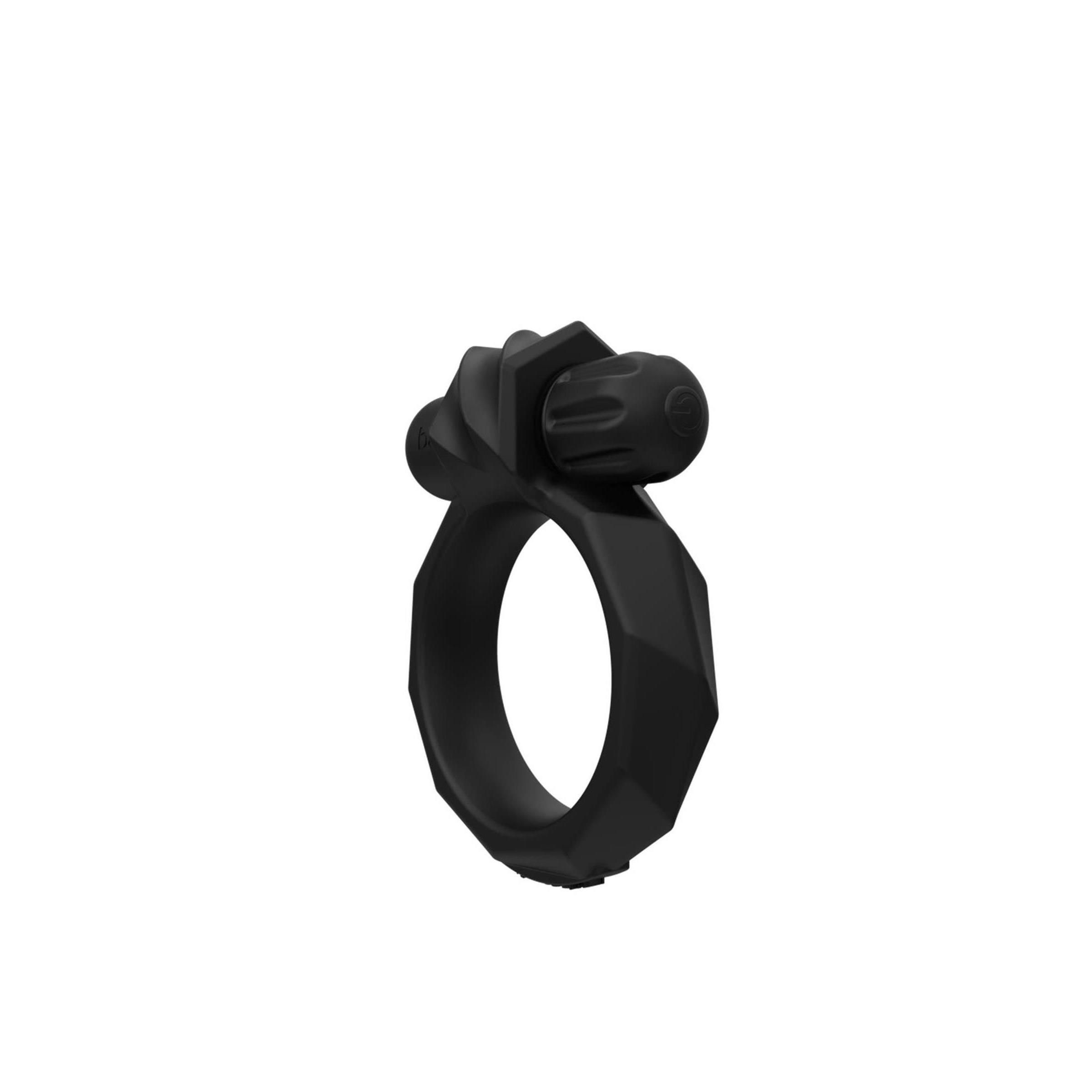 Schwarzes Produkt mit ringförmigem Design und einem Aufsatz. Der Ring hat eine polygonale Form.