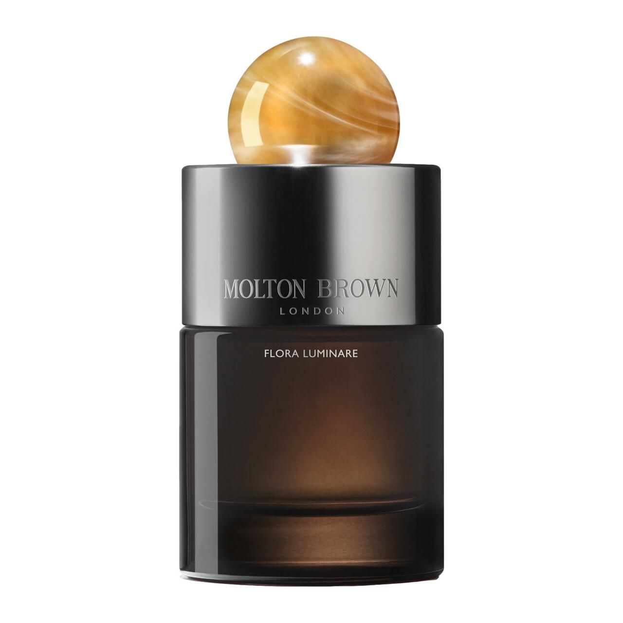 Dunkelbrauner Flakon mit silbernem Deckel und kugelförmigem Verschluss. Aufschrift: MOLTON BROWN LONDON, FLORA LUMINARE.