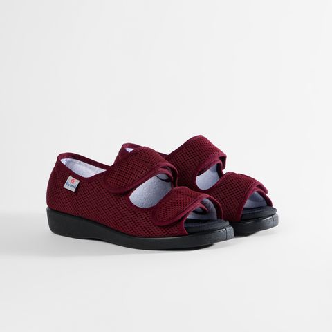 Rote Sandalen für Damen mit Klettverschluss, eine davon geöffnet.