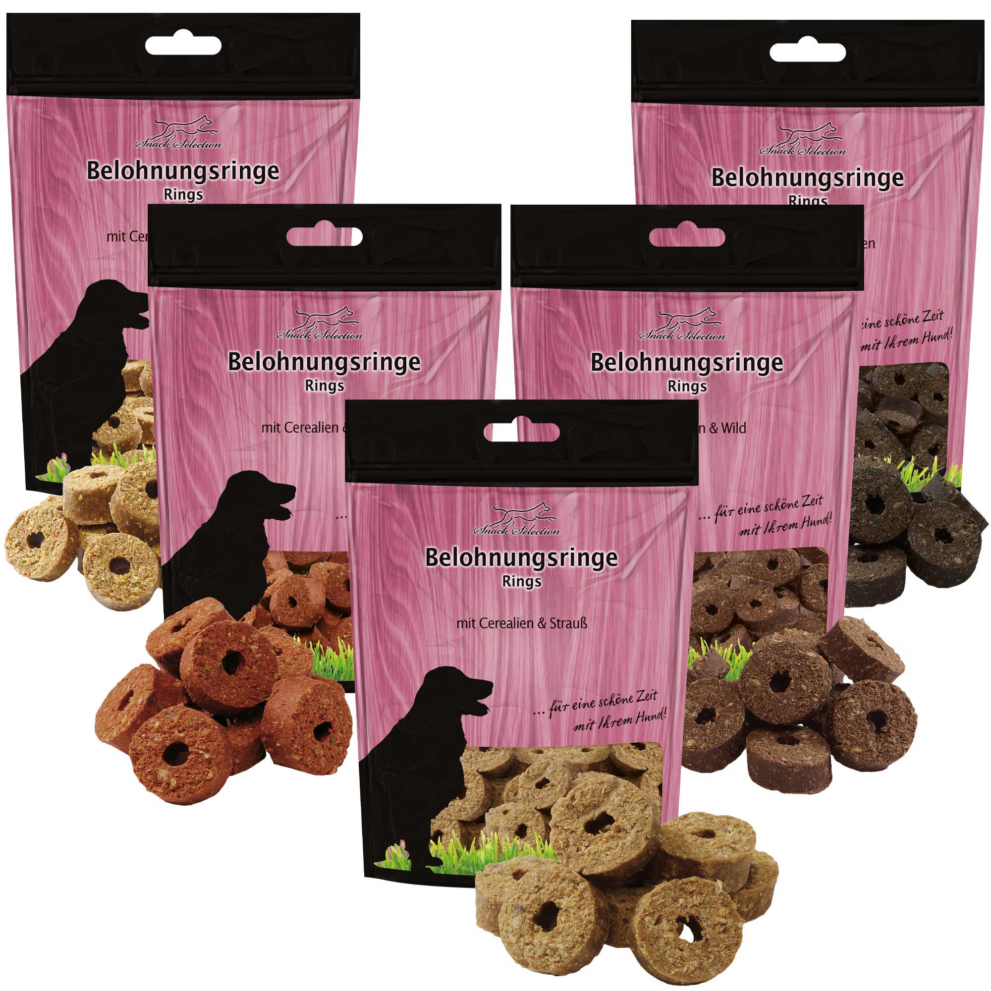 Mehrere Beutel Hundesnacks mit Belohnungsringe. Verschiedene Farben und Geschmacksrichtungen. Schwarzer Beutel mit Produktnamen.