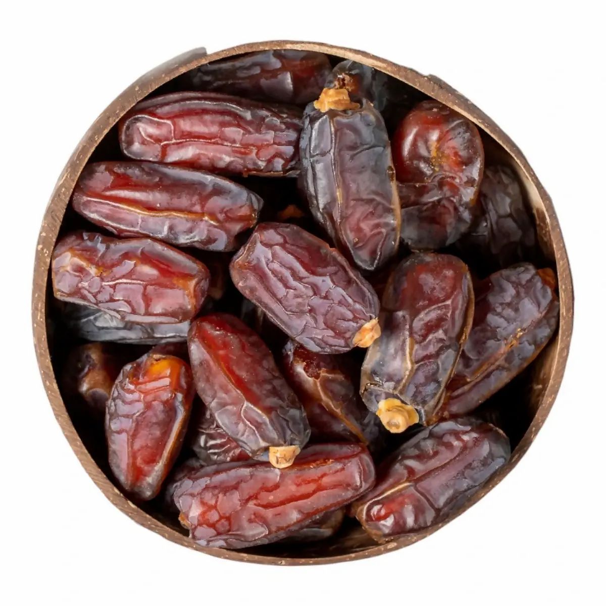 Runde Schale gefüllt mit Datteln. Sicht von oben. Dunkelbraune Datteln in einer runden Schale.