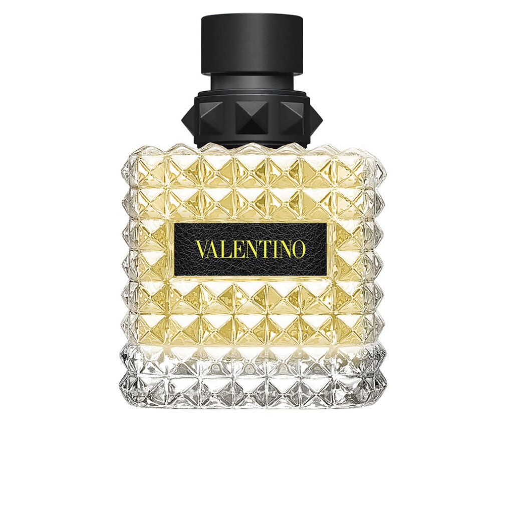 Parfümflakon mit quadratischem Design und pyramidenförmigen Details. Schwarzer Verschluss. VALENTINO Schriftzug auf schwarzem Feld.