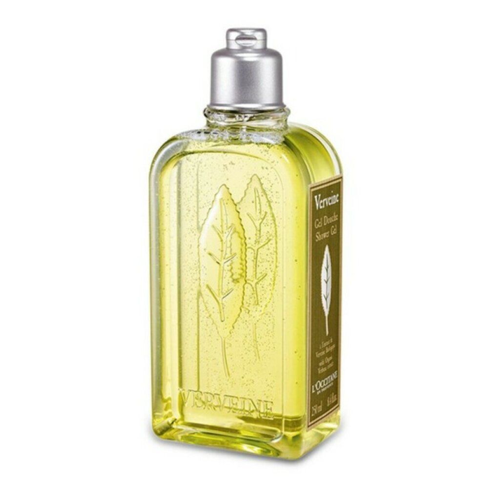 Gelbe Flüssigkeit in einer rechteckigen Flasche mit silbernem Deckel. Aufschrift: Verbene, Gel Douche, L'Occitane. Blattrelief.