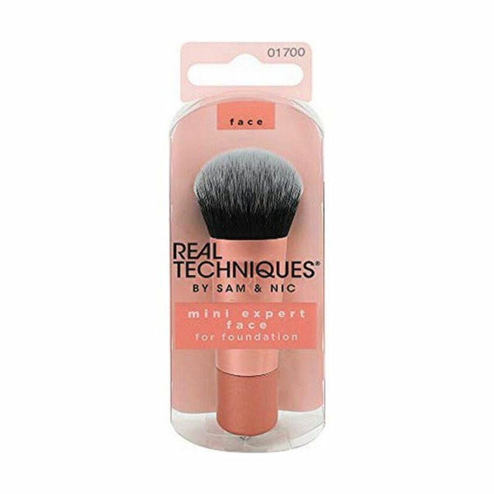 Mini Expert Face Brush in Verpackung. Rosafarbener Griff, schwarze und graue Borsten. Text: Real Techniques.