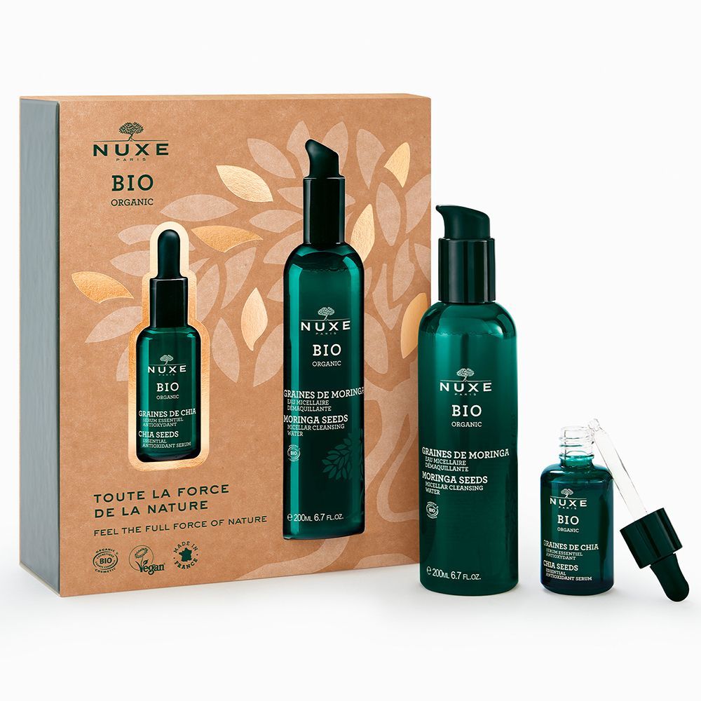 Geschenkset mit grünen Flaschen und einer Pipette. Aufschrift: NUXE BIO. Verpackung mit Blättern und Text.