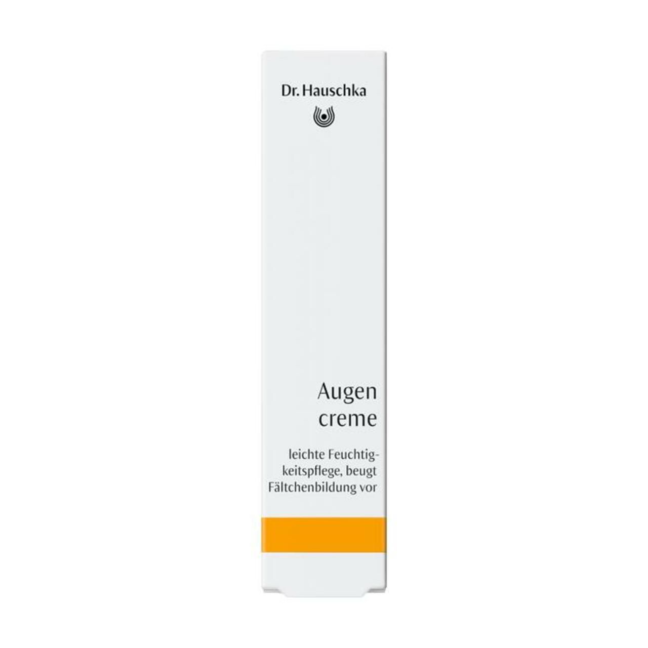Weiße Verpackung mit gelbem Streifen. Aufschrift: Dr. Hauschka, Augencreme, leichte Feuchtigkeitspflege, beugt Fältchenbildung vor.