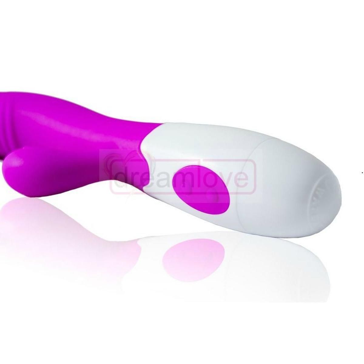 Nahaufnahme eines Vibrators. Lila und weiß. Ein Knopf ist sichtbar. Das Produkt spiegelt sich.