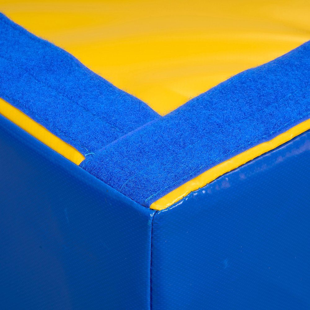 Detailansicht einer Ecke des blau-gelben Podests. Blaue und gelbe Materialien, Nähte sichtbar.