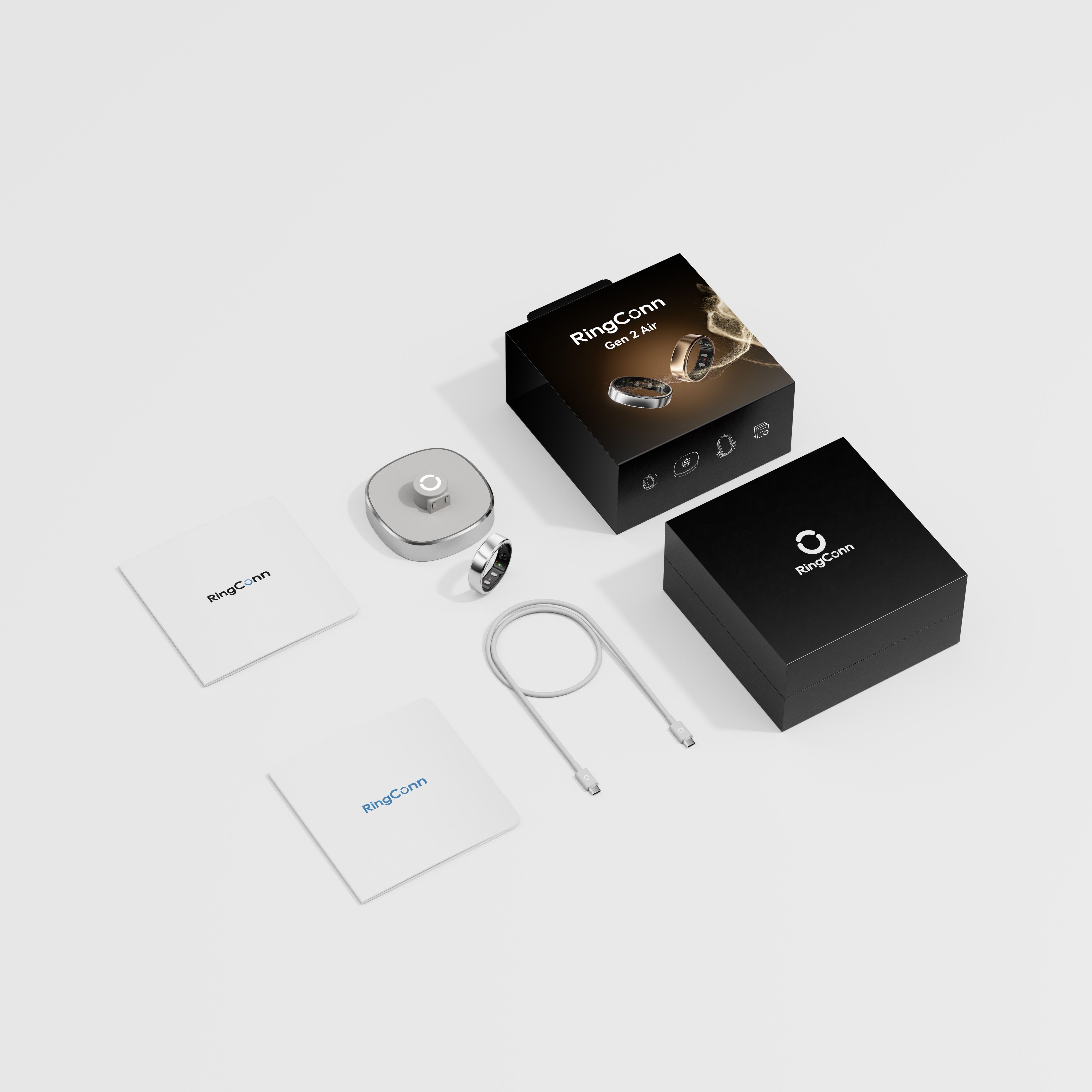 Produktverpackung mit Ring, Ladezubehör und Dokumenten. Schwarze Schachteln mit Logo. Ringconn Gen 2 Air.