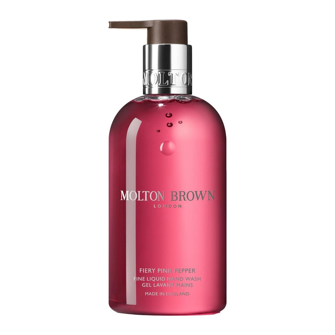 Molton Brown Fiery Pink Pepper Handseife. Runde Flasche mit Pumpe. Rosa Flüssigkeit. Silberne und braune Akzente. Text: Molton Brown London.