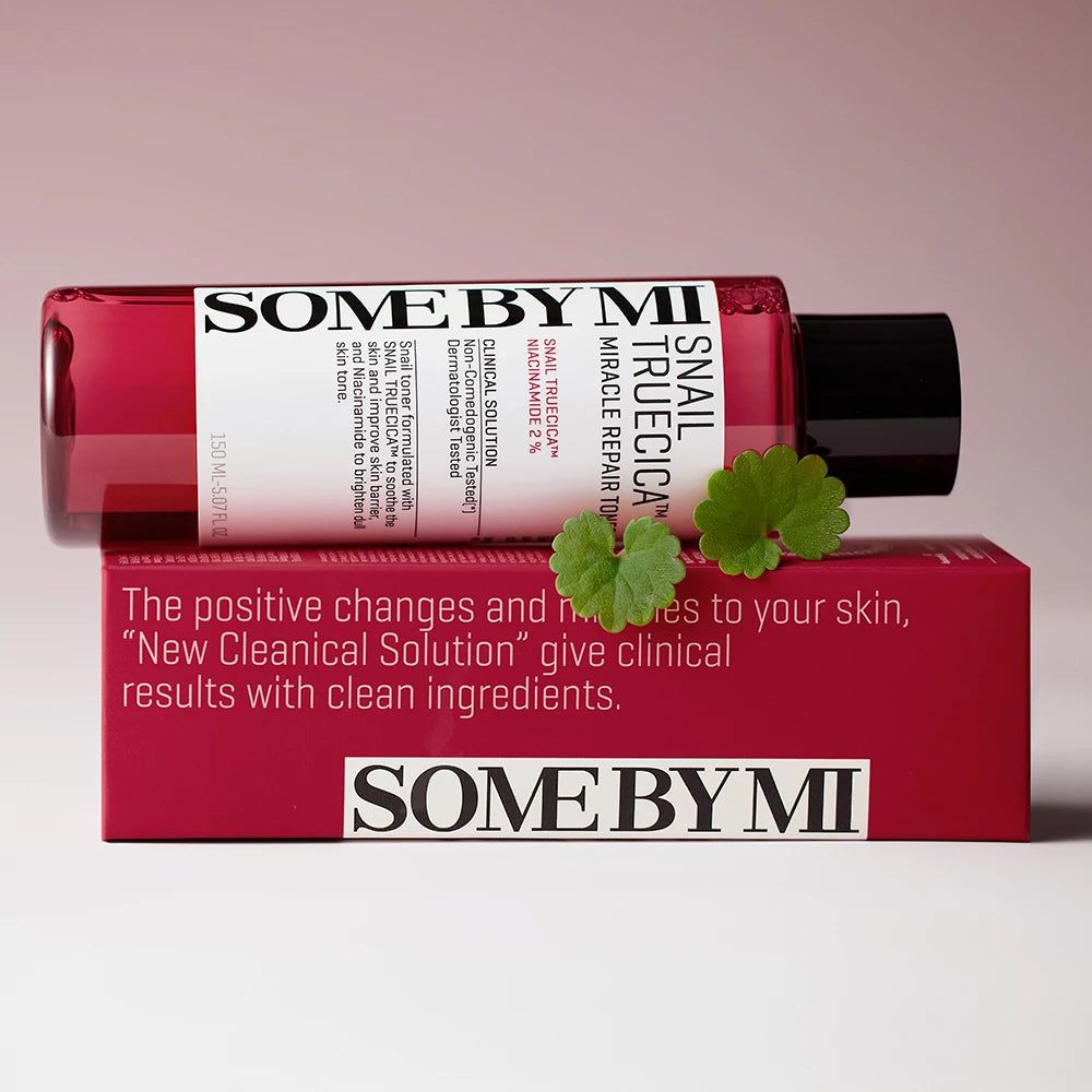 Rote Flasche SOME BY MI Snail TrueCICA Miracle Repair Toner und Schachtel mit Text. Grüne Blätter liegen daneben.