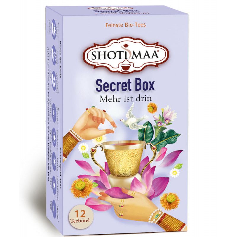 Karton "Secret Box" mit 12 Teebeuteln. Aufdruck: "SHOTI MAA", Hände, Tasse, Blumen. Lila Hintergrund.