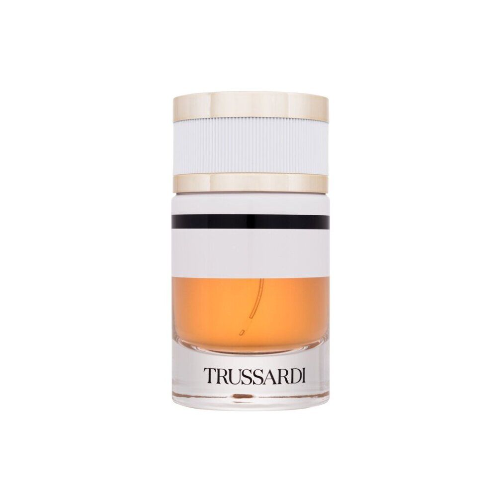 Parfümflakon. Zylindrisch, transparent, weiß, gold und schwarz. Aufschrift: Trussardi. Flüssigkeit: bernsteinfarben.