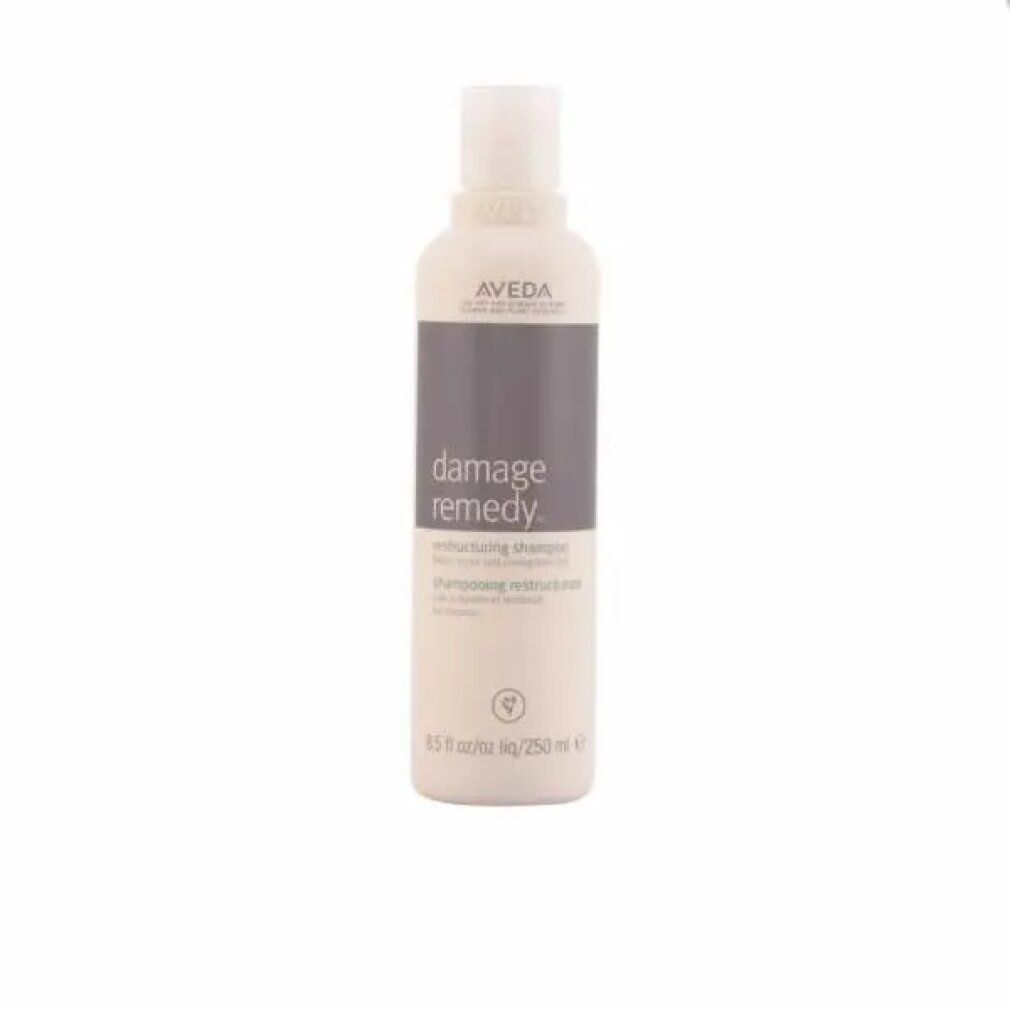 Beige Shampoo-Flasche mit grauem Etikett. Aufschrift: Aveda, Damage Remedy, Restructuring Shampoo. 250 ml.