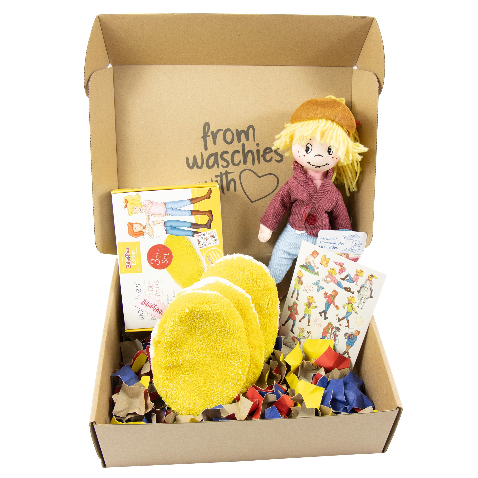 Geschenkbox mit Puppe, gelben Waschies, Karte und Konfetti. Aufschrift: from waschies with love.