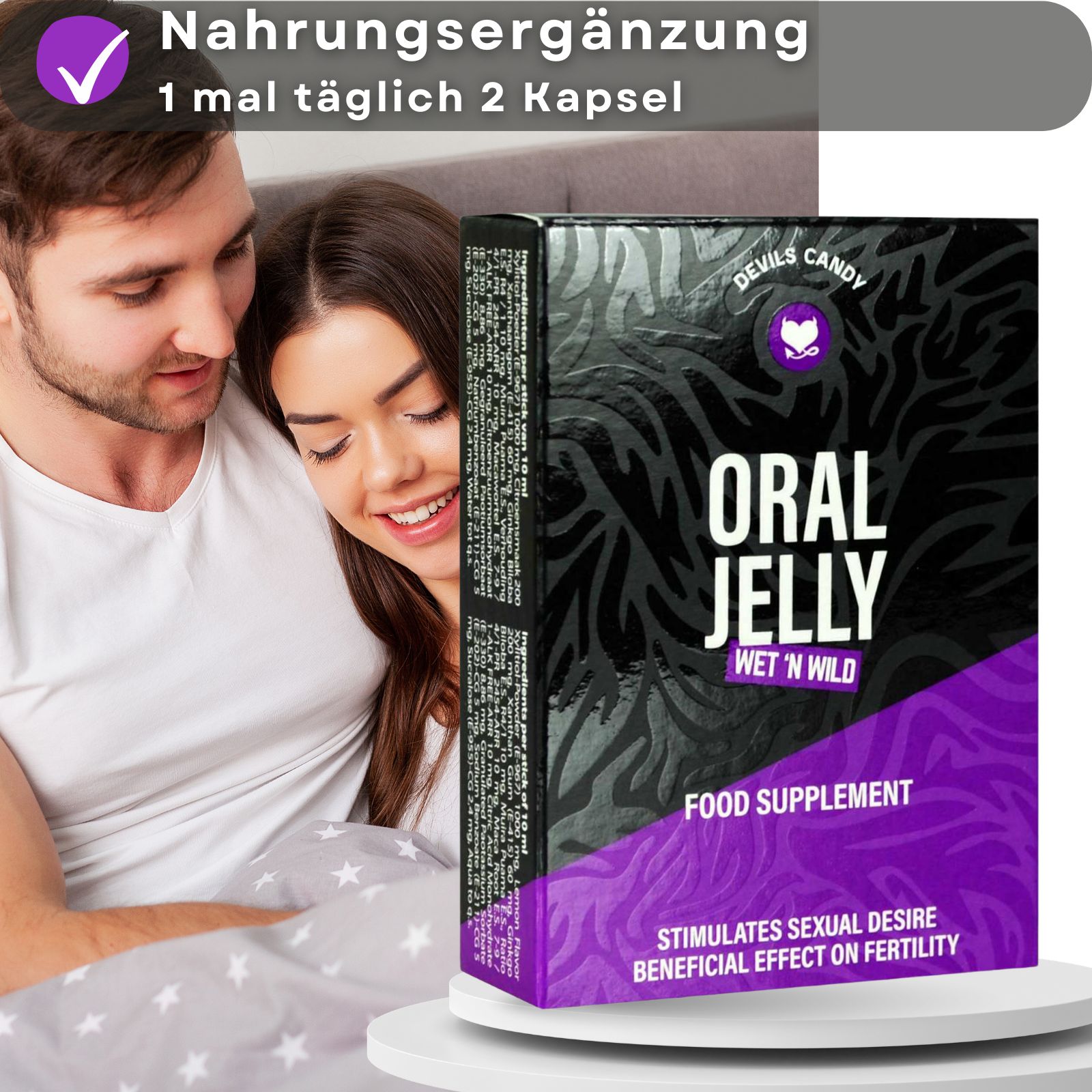 Paar im Bett. Schachtel mit „Oral Jelly“ Schriftzug. Enthält „Wet 'n Wild“ und „Food Supplement“. Lila Akzente.