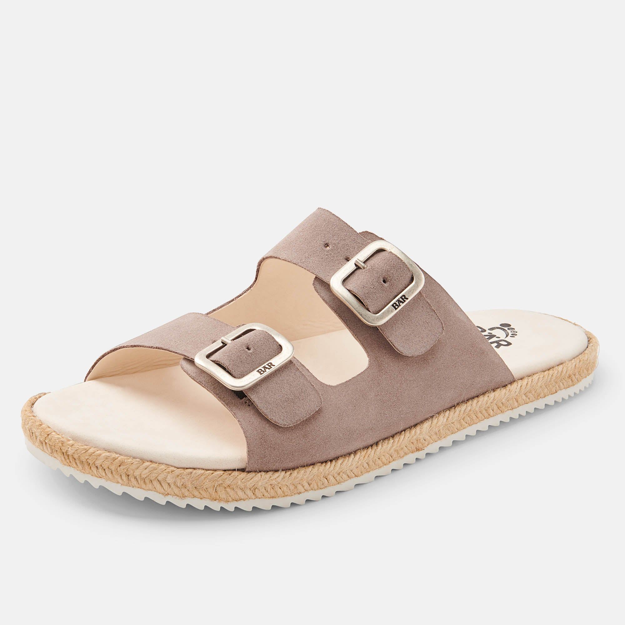 Beige Pantolette mit zwei Schnallen. Die Sohle ist weiß, der Rand geflochten. BAR ist auf den Riemen geprägt.
