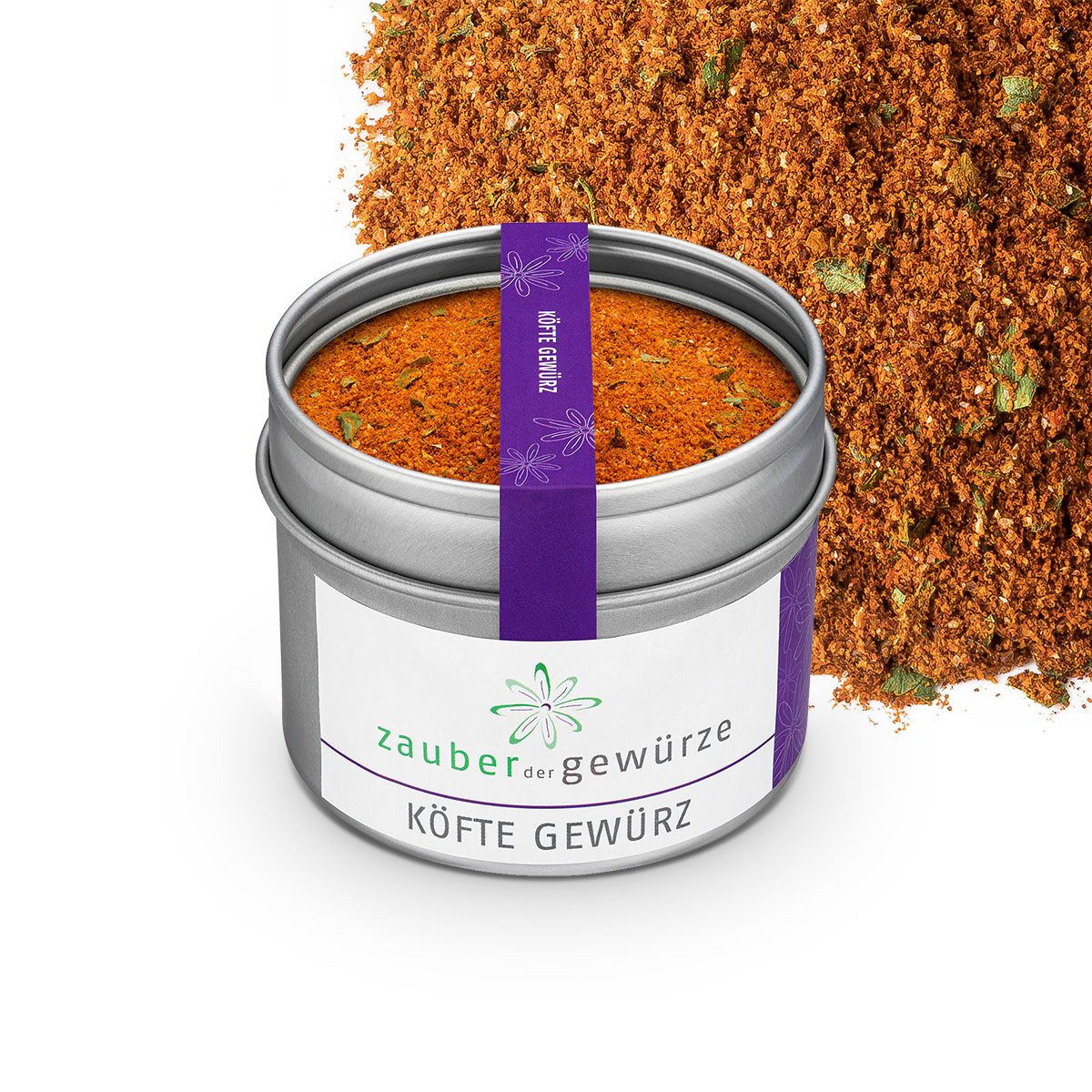 Geöffnete Dose Köfte Gewürz. Aufschrift: Zauber der Gewürze, Köfte Gewürz. Lila Band mit Aufschrift. Gewürz daneben.
