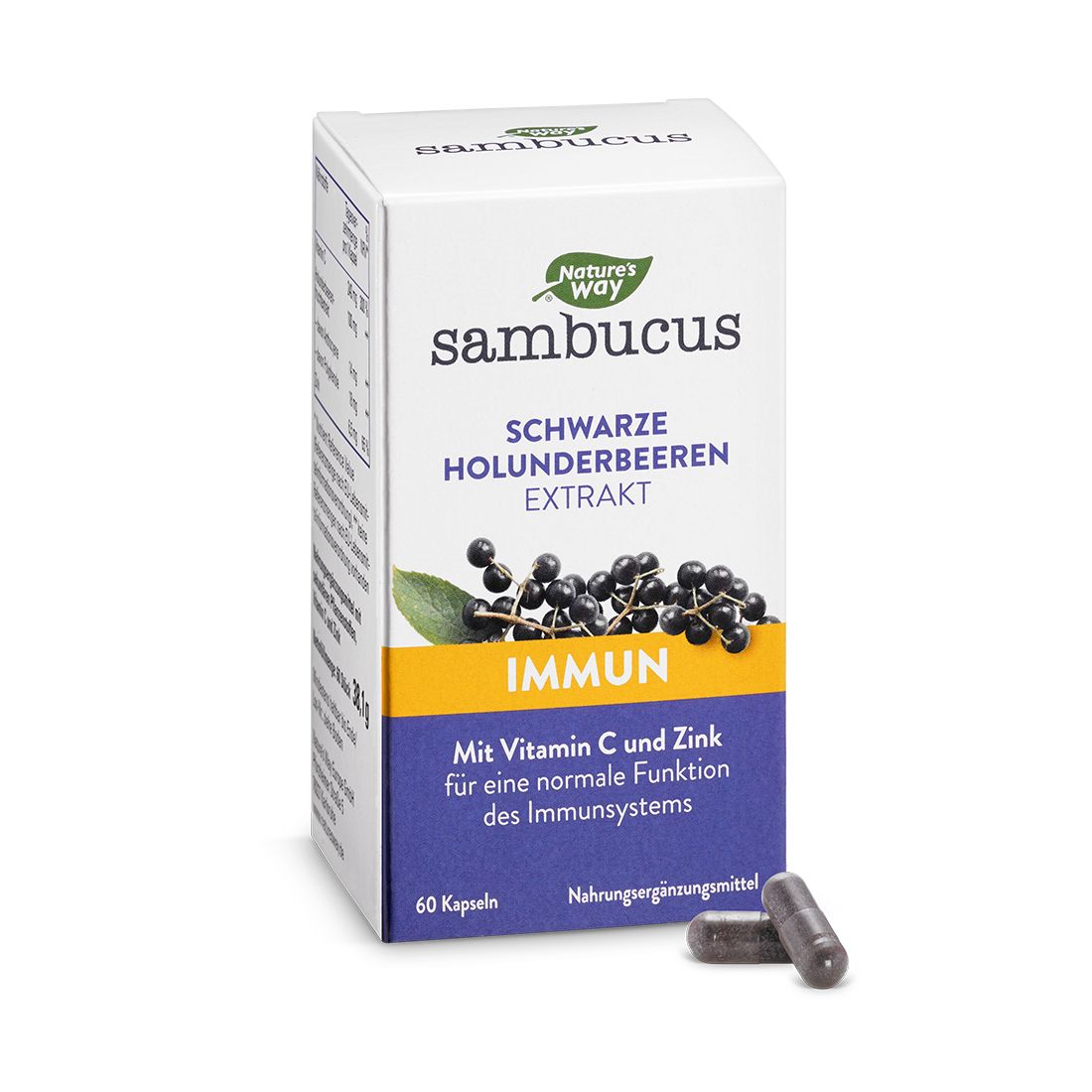 Weißer Karton mit Produktaufdruck. Aufschrift: Sambucus, Holunderbeeren Extrakt, Immun. Zwei Kapseln liegen daneben.
