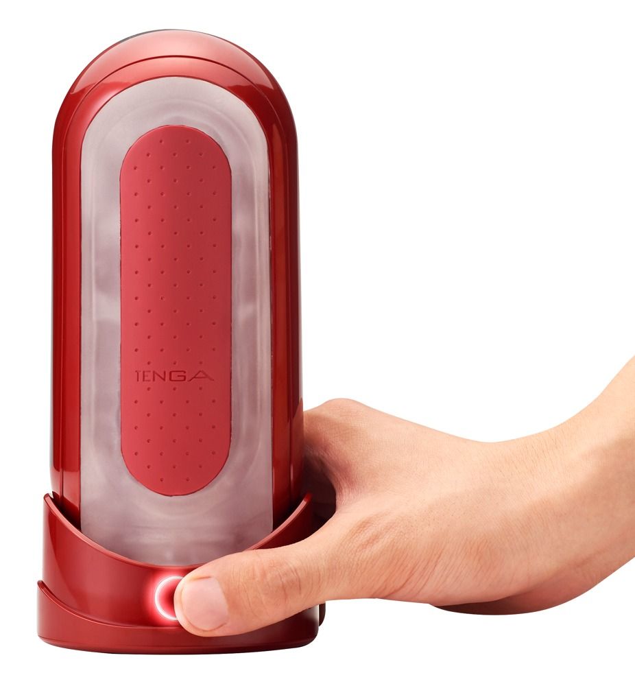 Roter TENGA Flip 0. Hand drückt Knopf. Zylindrische Form mit roter Innenfläche und transparentem Gehäuse.