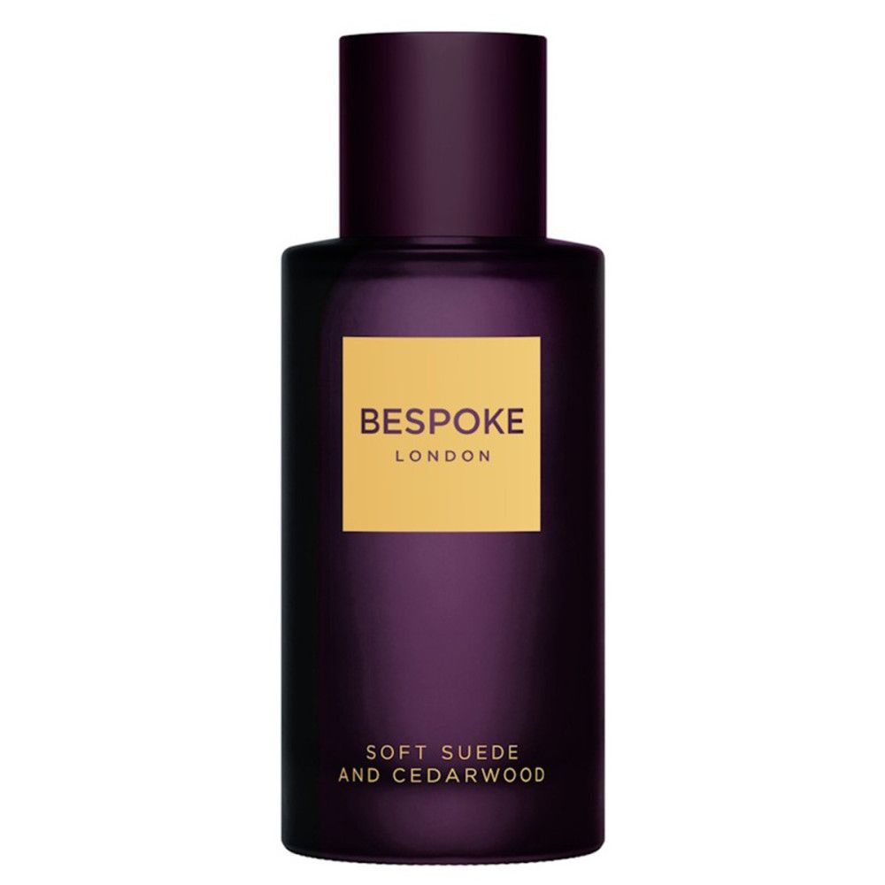 Dunkelviolette Flasche mit goldfarbenem Etikett. Text: Bespoke London, Soft Suede & Cedarwood. Vertikale Ansicht.