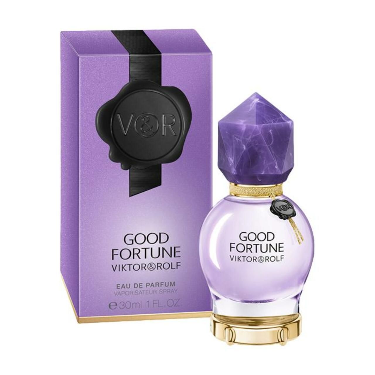 Violetter Flakon und Verpackung. Flakon rund mit Kristallverschluss. Verpackung mit schwarzem Siegel und Aufschrift.