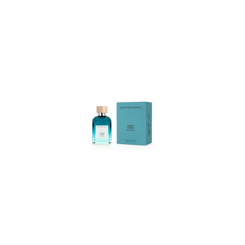 Blau-transparente Flasche mit Holzdeckel und rechteckiger Schachtel. Aufschrift: Adolfo Dominguez, Citrus Cedro.