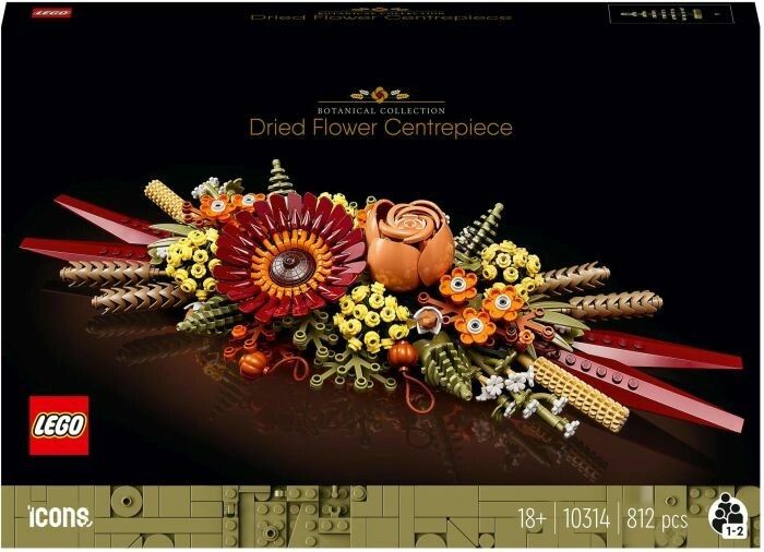 LEGO Icons 10314 Centrotavola di Fiori Secchi. La confezione mostra una composizione di fiori LEGO rossi, gialli e marroni. Il set contiene 812 pezzi ed è destinato a persone dai 18 anni in su. Il logo LEGO e la scritta "Botanical Collection" sono ben visibili.