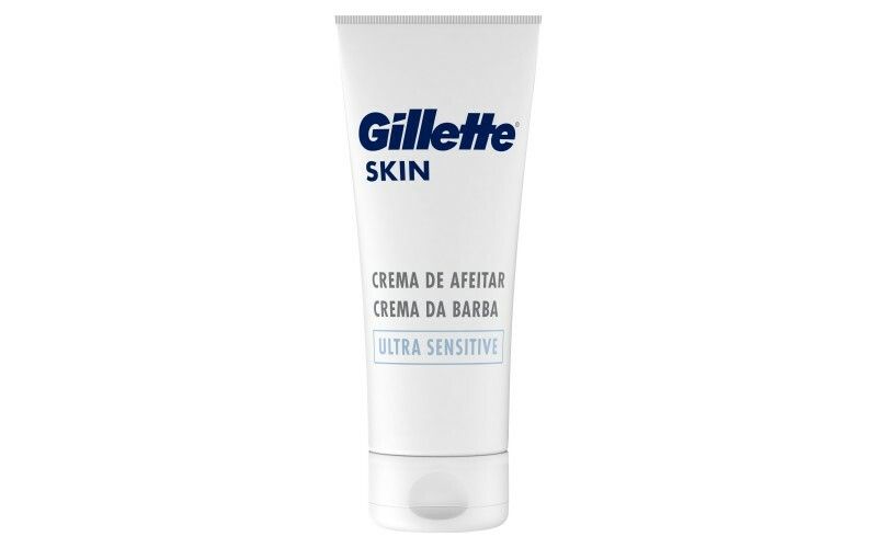 Weiße Tube mit blauem Gillette-Logo und SKIN-Schriftzug. Text: CREMA DE AFEITAR, ULTRA SENSITIVE. Produkt für empfindliche Haut.