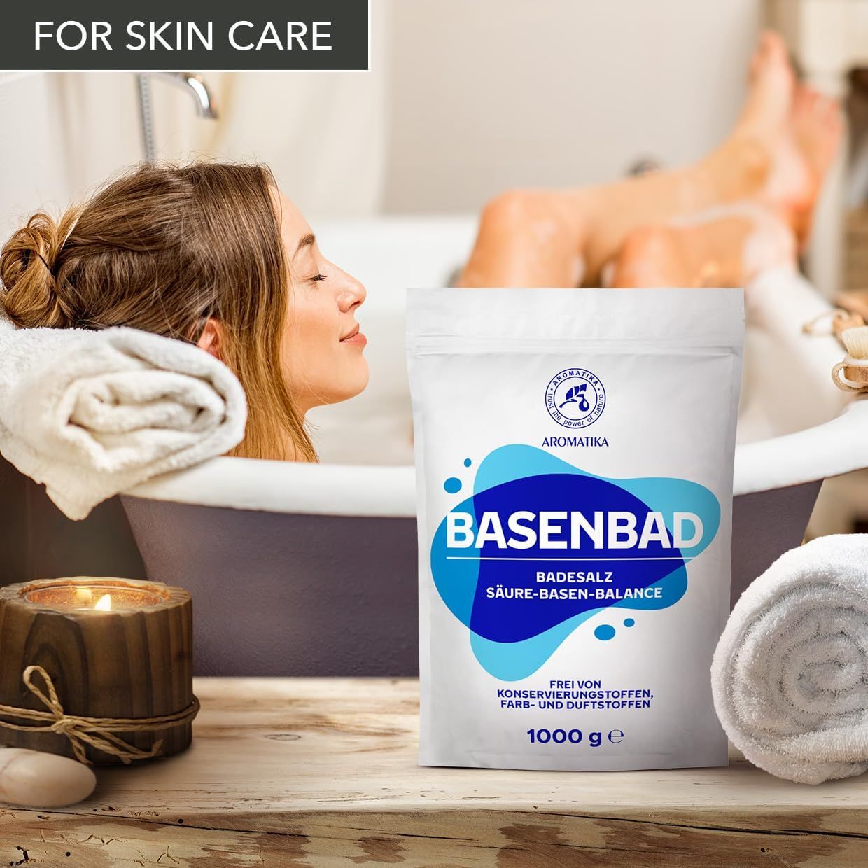 Weiße Verpackung mit blauem Design. BASENBAD, Badesalz, Säure-Basen-Balance. Logo: AROMATIKA. Frau in Badewanne. Kerze, Handtuch. Text: Frei von Konservierungsstoffen, Farb- und Duftstoffen. 1000 g.