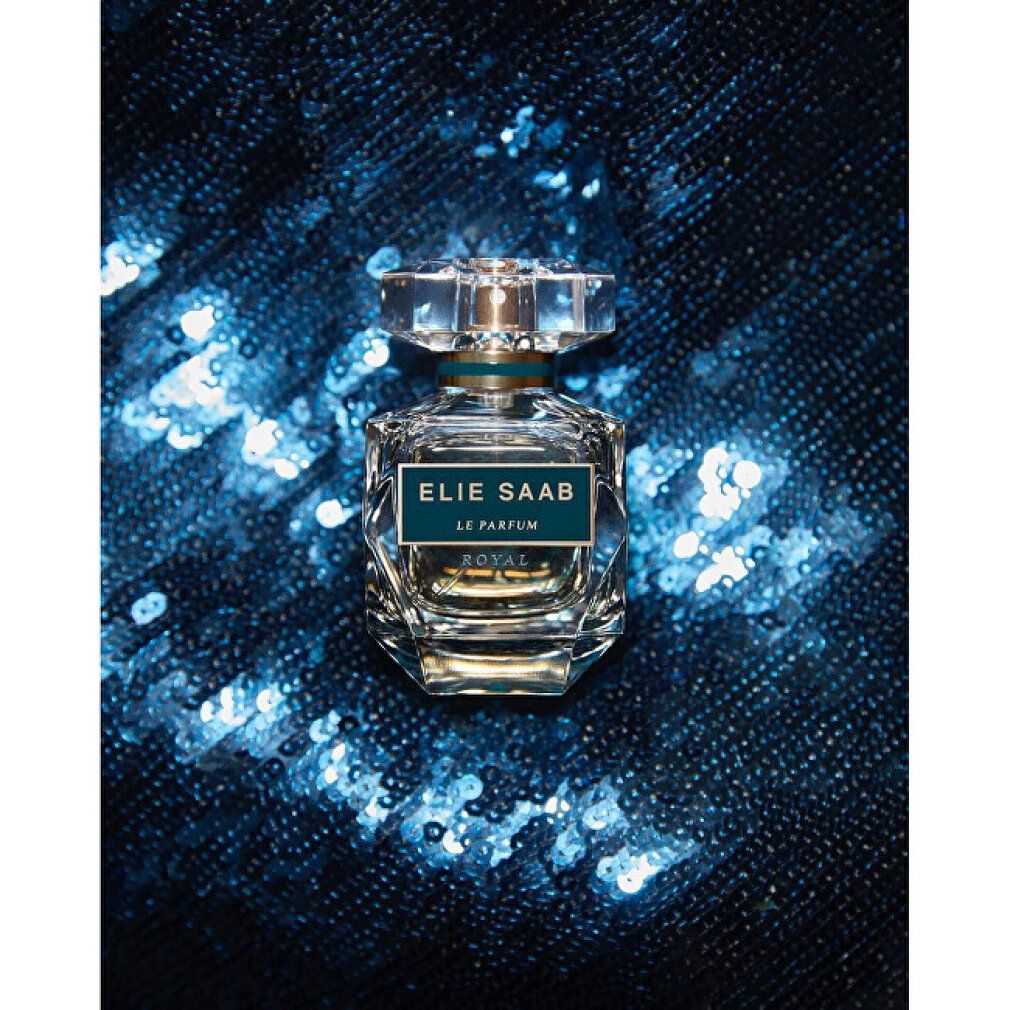 Parfümflakon auf blauem Hintergrund. Aufschrift: ELIE SAAB LE PARFUM ROYAL. Transparenter Deckel.