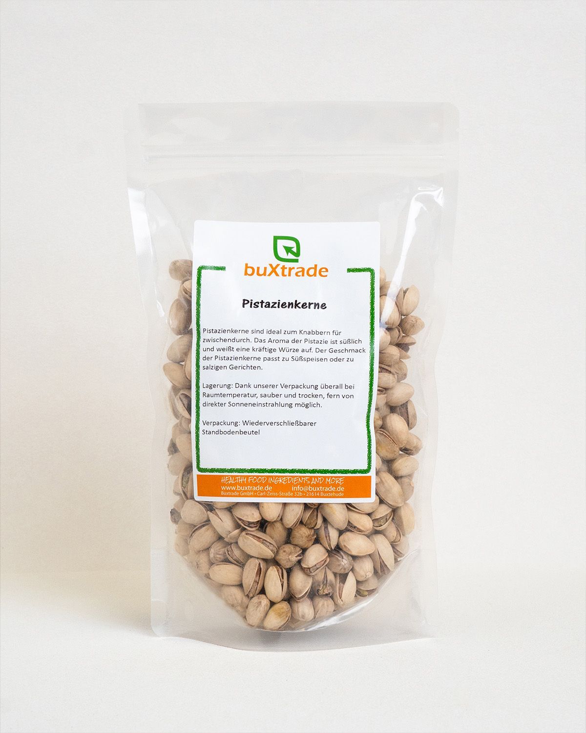 Transparente Verpackung mit Pistazienkernen. Aufkleber mit Produktinformationen. Marke: buXtrade.