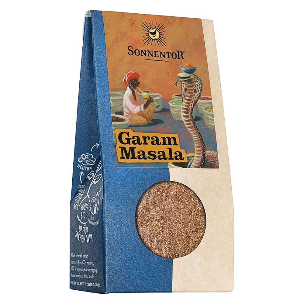 Verpackung mit rundem Sichtfenster. Aufdruck: Sonnentor, Garam Masala. Illustration: Schlangenbeschwörer und Kobra.