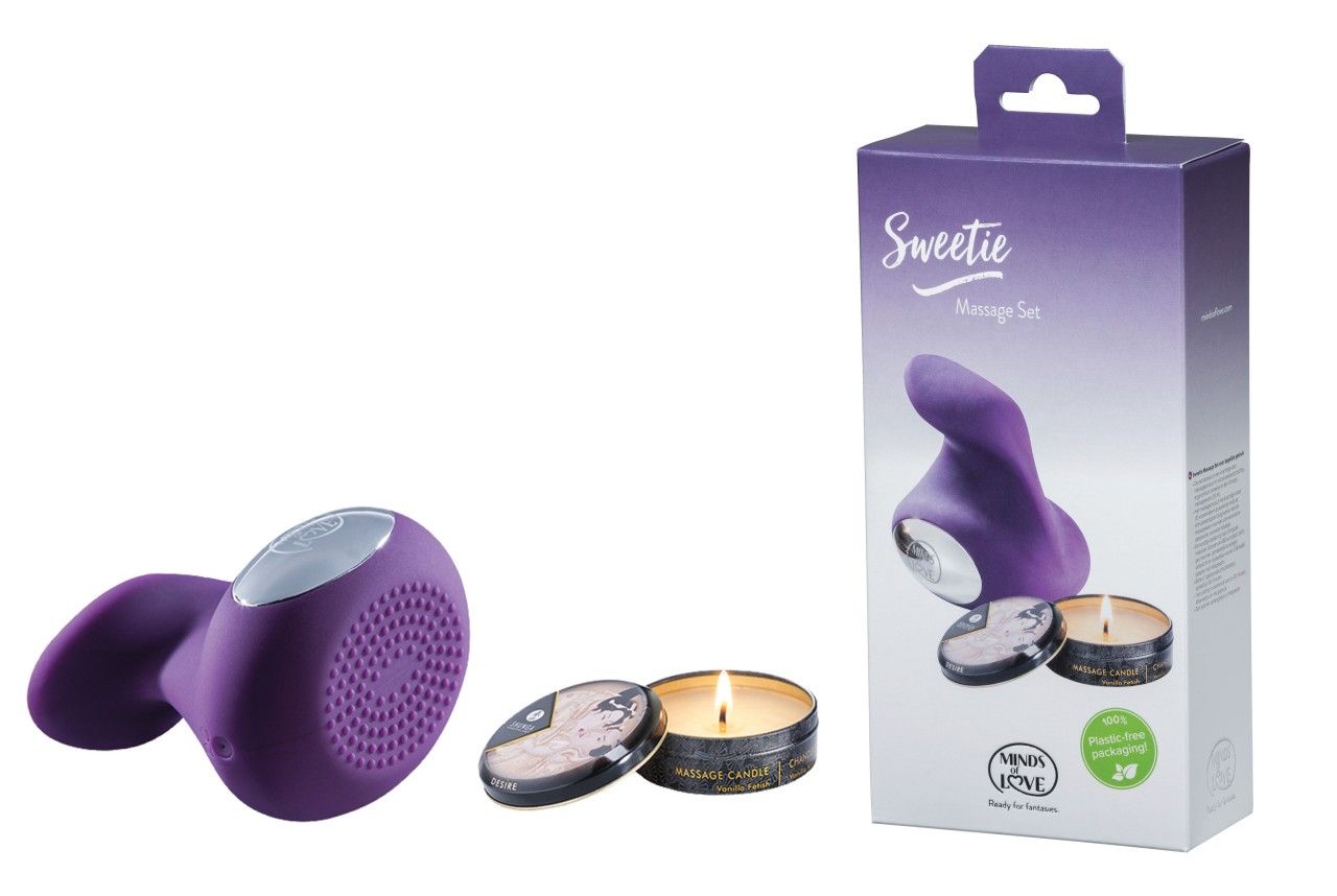 Lila Massagegerät, zwei Kerzen, eine davon brennend, und Produktverpackung mit Text "Sweetie Massage Set".
