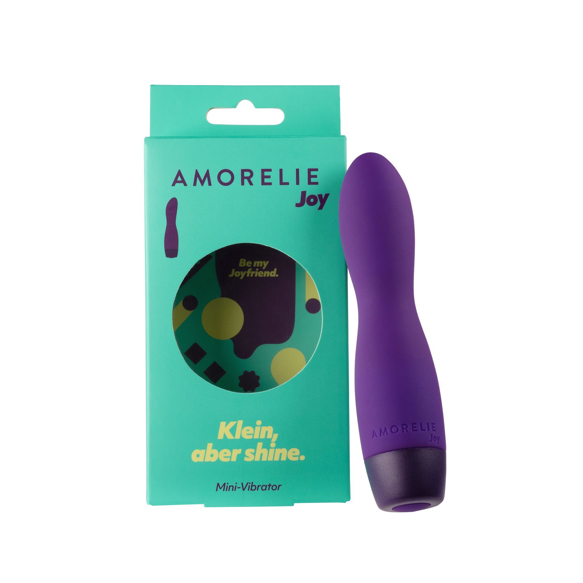 Mini-vibrateur violet et emballage vert. L'emballage porte le nom AMORELIE Joy, une illustration du produit et le slogan "Klein, aber shine."