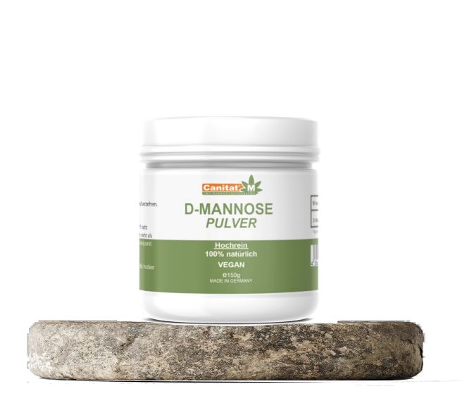 Weißes D-Mannose Pulver-Behälter auf Stein. Aufschrift: Canitat M, D-Mannose Pulver, vegan, 150g.