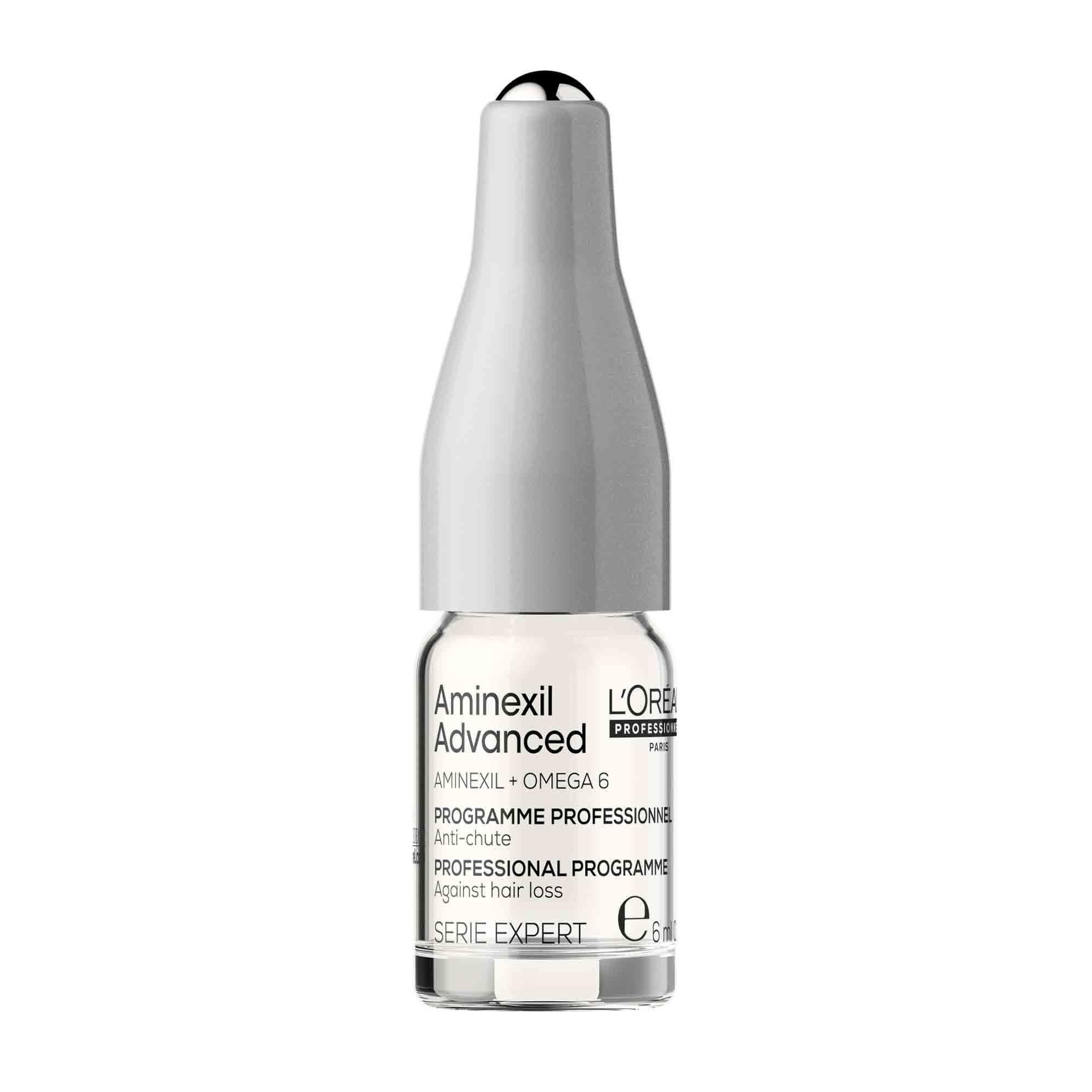 Einzelne Ampulle von L'Oréal Professionnel Anti-Haarverlust Aktivatorprogramm. Transparente Flasche mit silbernem Applikator.