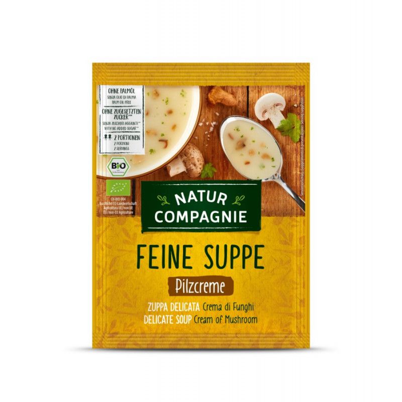 Gelbe Verpackung mit Natur Compagnie Pilz Cremesuppe. Text: Feine Suppe, Pilzcreme. Bio-Siegel.