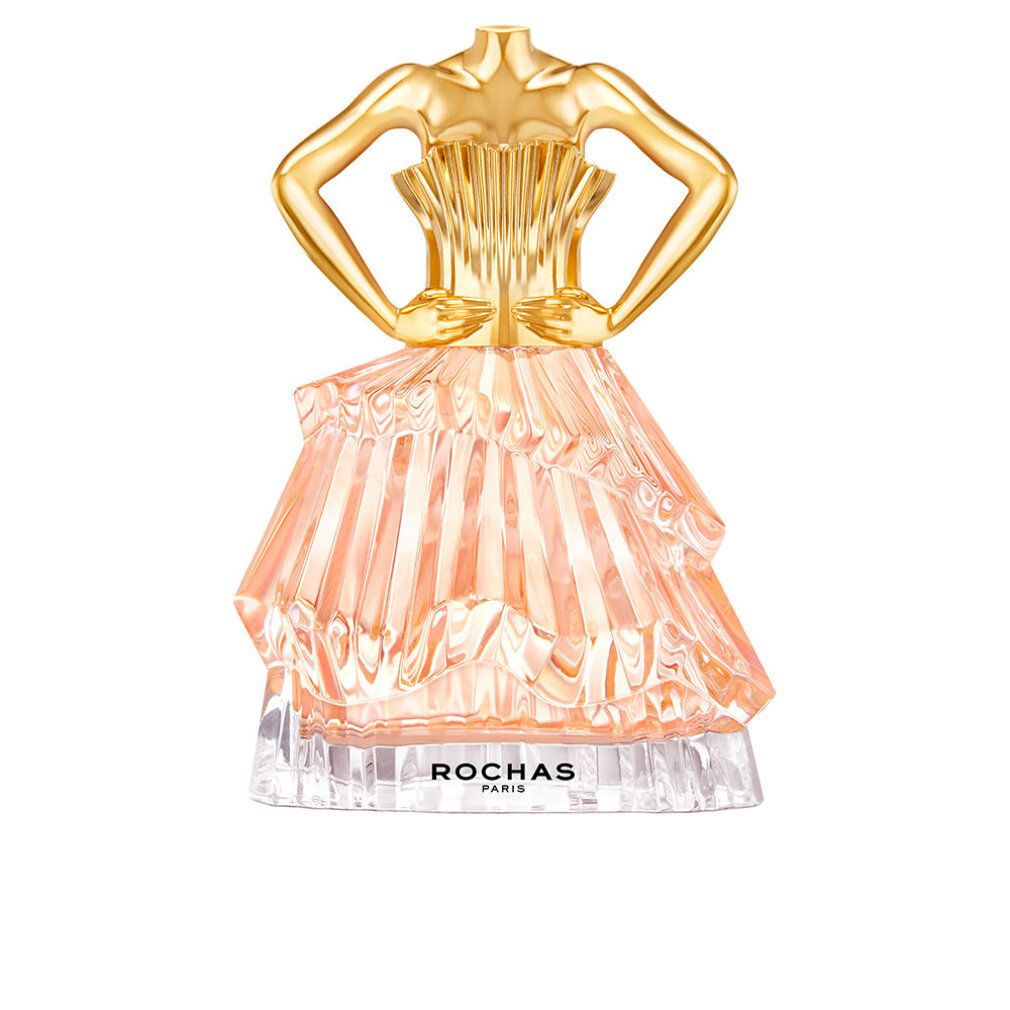 Parfümflakon in Form eines Kleides. Goldfarbener Oberteil, rosa Rock. Aufschrift: ROCHAS PARIS.