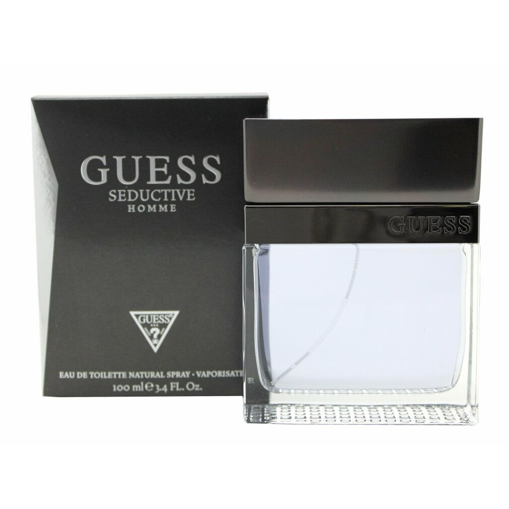 Guess Seductive Homme Eau de Toilette. Schwarzer Karton und Flakon. Flakon mit silbernem Deckel. Text: GUESS, Seductive Homme, Eau de Toilette.