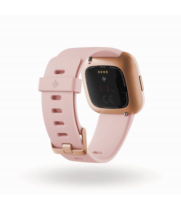 Rückseite des Fitness-Trackers. Rosafarbenes Armband, goldfarbenes Gehäuse. Sensoren und Ladekontakte sichtbar.