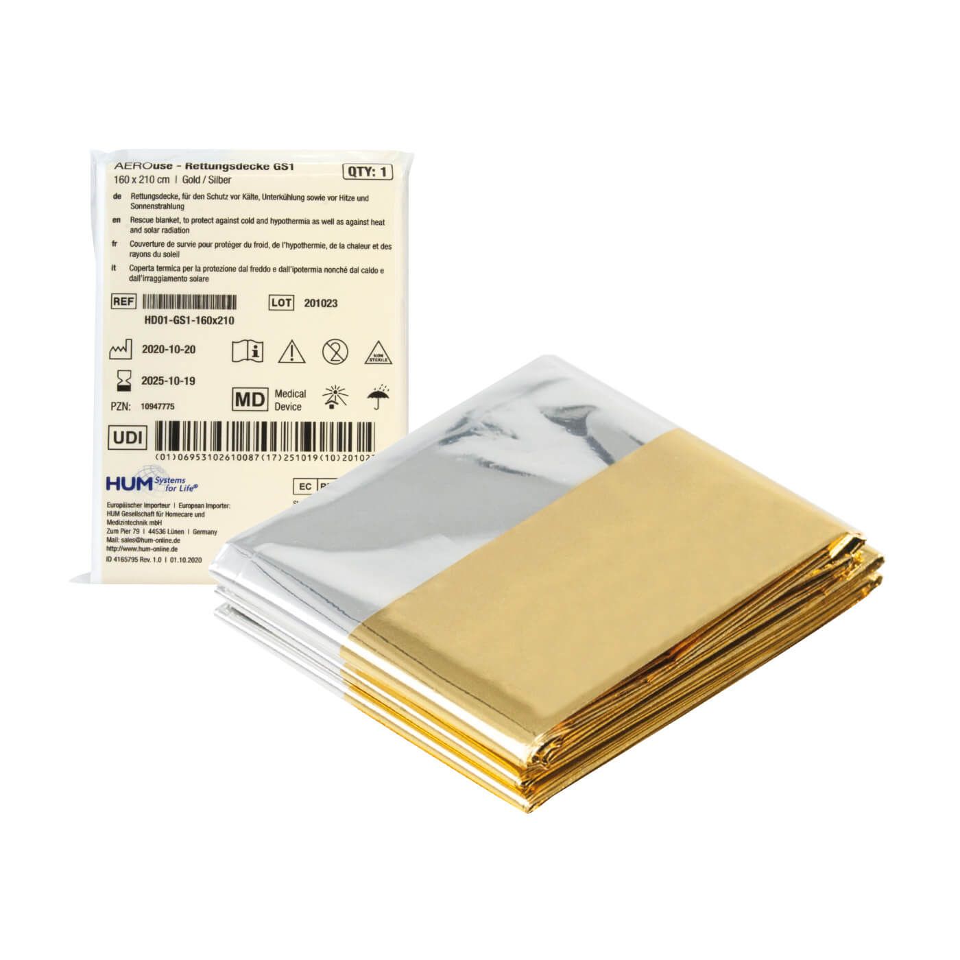 Silber-goldfarbene Rettungsdecke, gefaltet. Verpackung mit Produktinformationen. Aufschrift: HUM AEROuse.