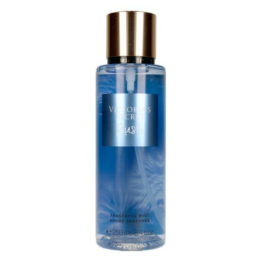 Victoria's Secret Rush Fragrance Mist. Blaue Flüssigkeit in einer zylindrischen Flasche. Goldfarbener Deckel. Produktname auf Etikett.