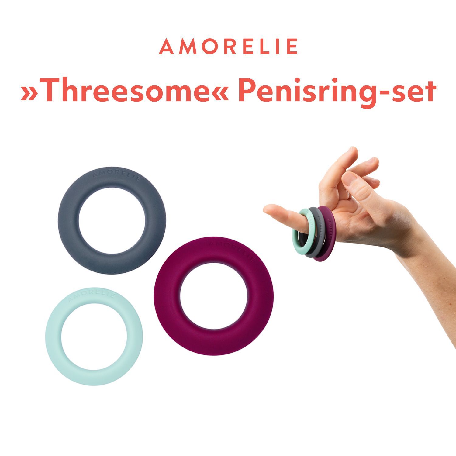 Drei Penisringe in Grau, Lila und Mintgrün. AMORELIE-Logo. Hand mit Ringen.